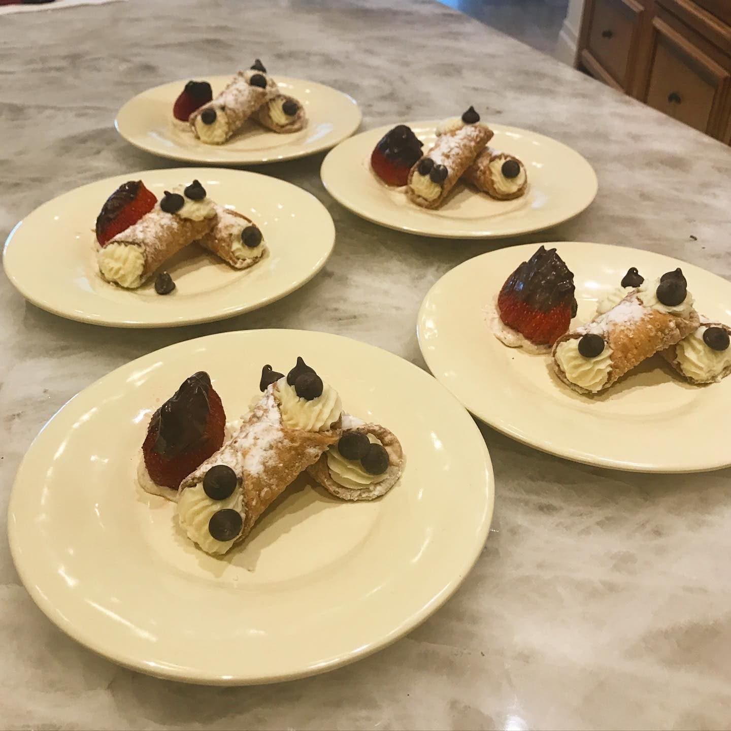 Plated cannoli with chocolate-dipped strawberries
