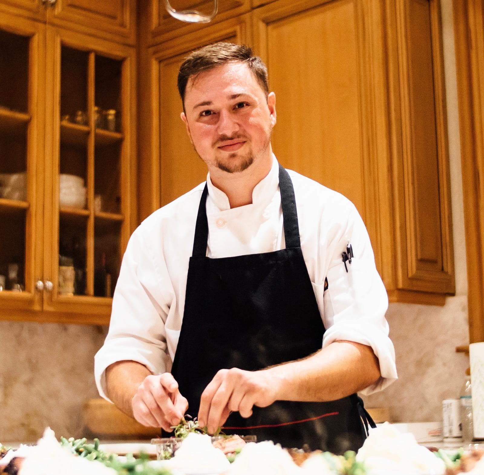 Portrait of Chef Pablo Sarmiento plating a signature dish