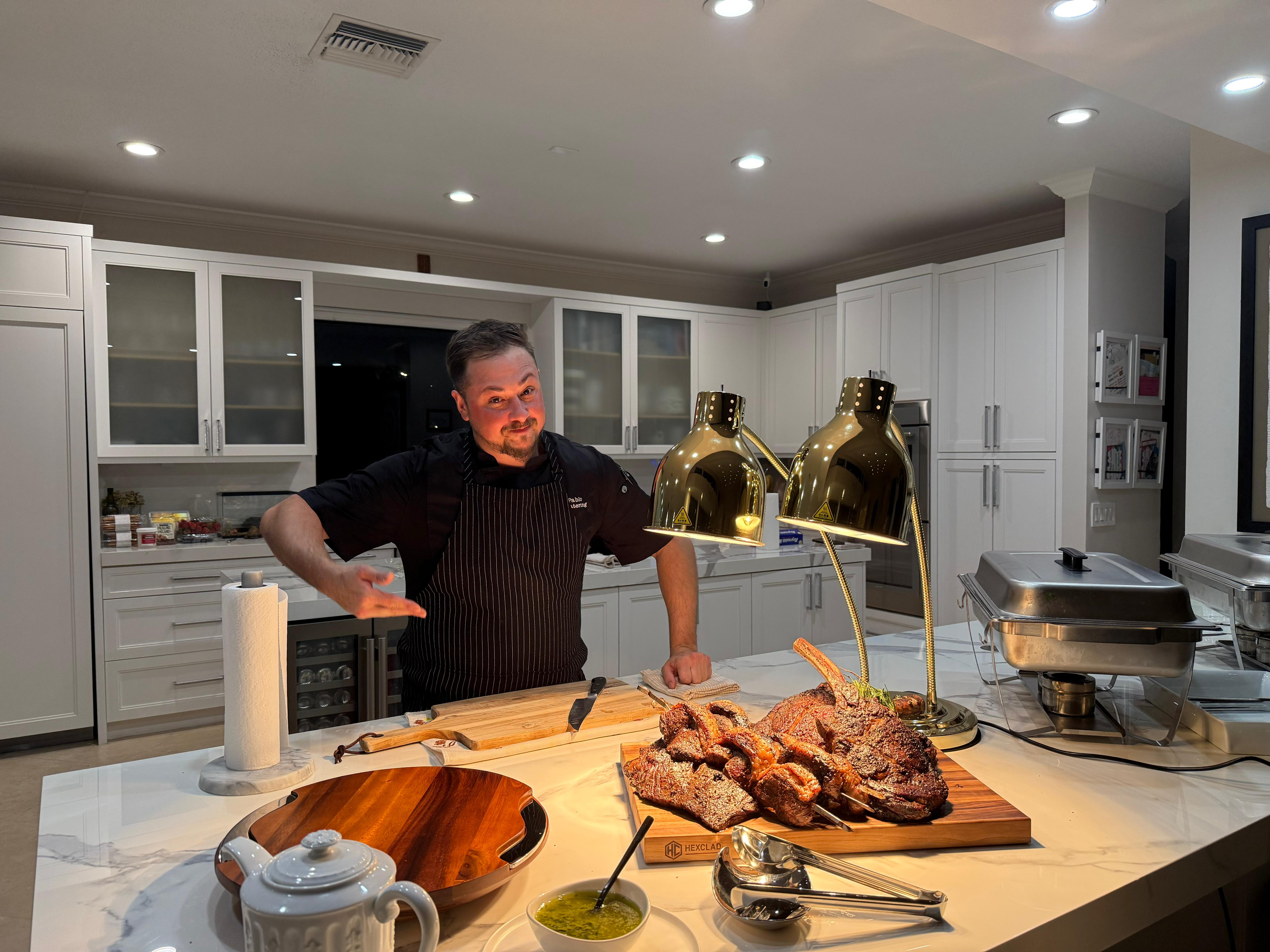 Chef Pablo Sarmiento presenting a roasted prime rib in his kitchen