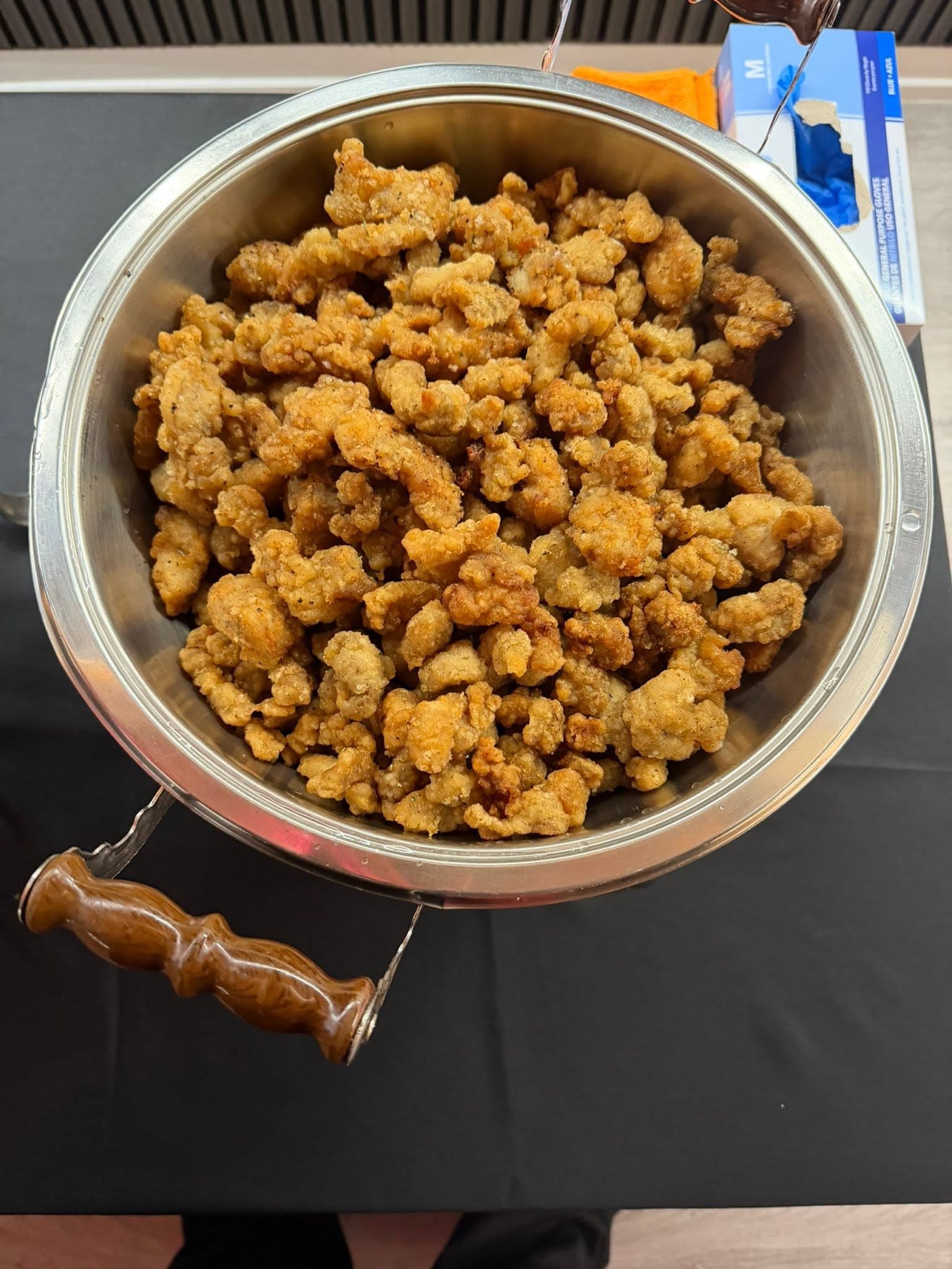 Crispy popcorn chicken in a buffet pan
