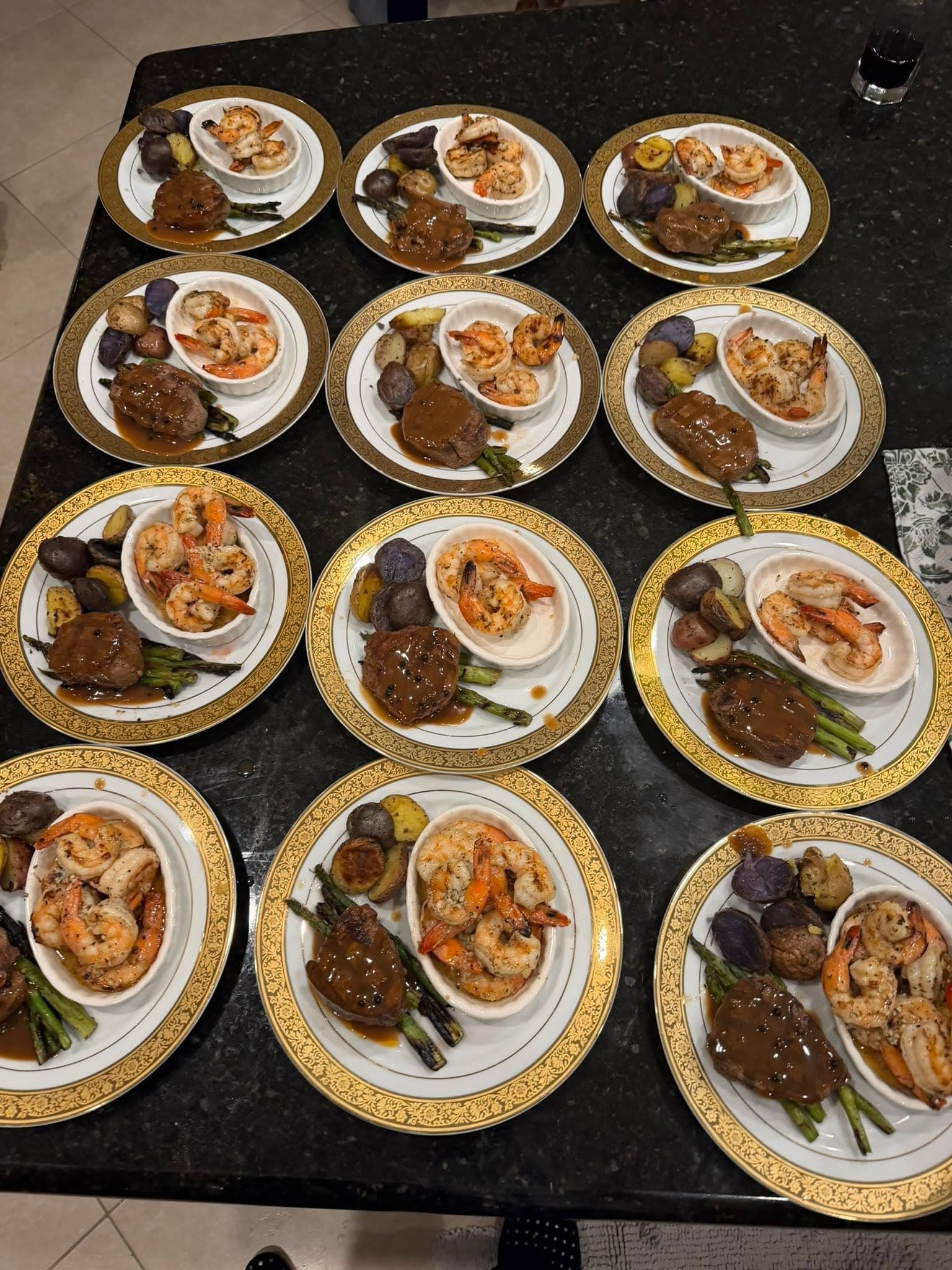 Plated filet and shrimp dinners lined up for service